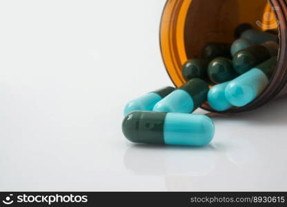 Medical pills spilling out of a toppled from pill bottle