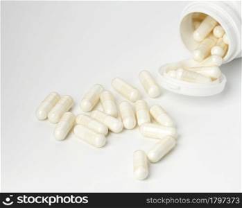 medical powder in white capsules on a white background. Treatment pills, nutritional supplements. White background