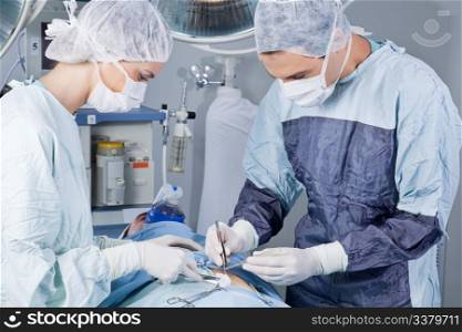 Medical professionals carrying on surgery on patient in operation theatre