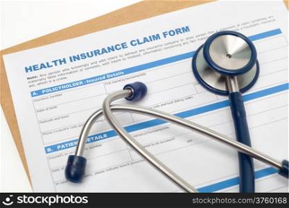 Medical reimbursement with health insurance claim form and stethoscope