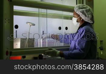Medical research center and industrial facility, female technician at work and cleaning vaccine test tubes in scientific laboratory. Sequence