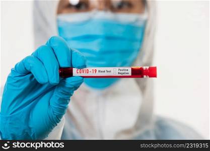 Medical scientist in PPE uniform wear a mask holding test tube Coronavirus test blood sample in a hospital laboratory for analyzing isolated on white, medicine COVID-19 pandemic outbreak concept