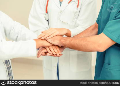 Medical service teamwork - Doctor, surgeon and nurse join hands together.