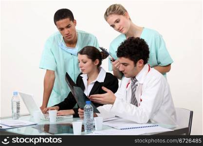 Medical staff gathered by desk