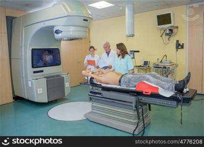 Medical staff observing man having scan