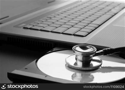 Medical stethoscope examining CD - DVD for viruses