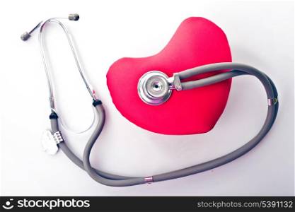 Medical stethoscope with red heart isolated on white
