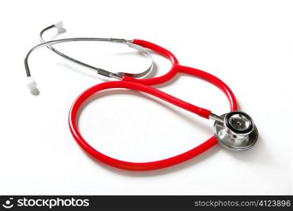 Medical still photo with red stethoscope over white background