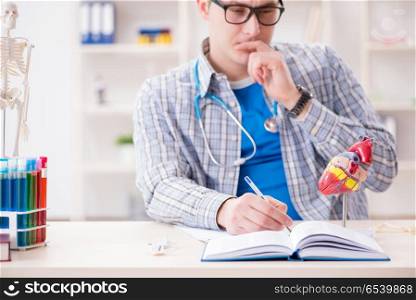 Medical student studying heart in classroom during lecture
