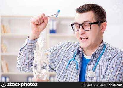 Medical student studying skeleton in classroom during lecture