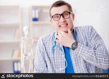 Medical student studying skeleton in classroom during lecture