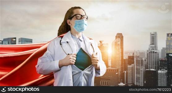 Medical superhero. Heroic doctor wearing mask and red cape fighting with epidemic in city. Young woman. Brave medical staff concept.. Heroic doctor fighting with epidemic