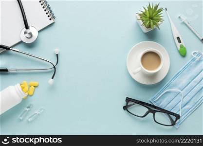 medical supplies with cup coffee succulent plant blue backdrop