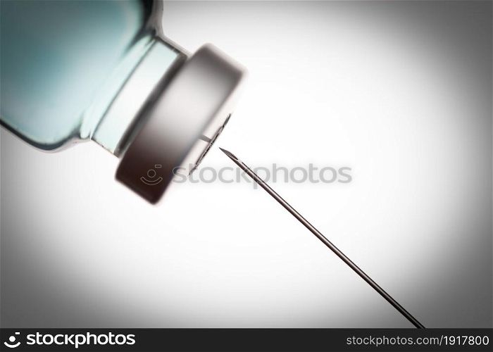 Medical Syringe Needle and Vaccine Vial Against White Background.