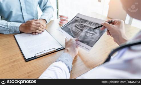 Medical team discussing, health care talking to female patient, Medical conferrence concept, doctor holding and looking at dental x-ray attending a client