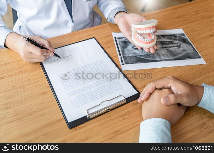 Medical team discussing, health care talking to female patient, Medical conferrence concept, doctor holding and looking at dental x-ray attending a client