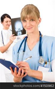 Medical team doctor young nurse female smiling look head x-ray