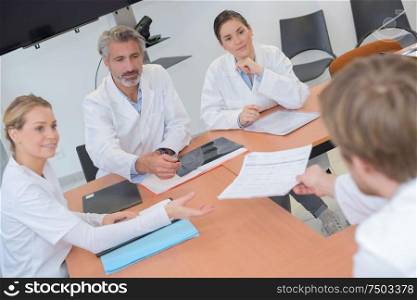 medical team interacting at a meeting in conference room