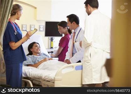 Medical Team Meeting Around Female Patient In Hospital Room