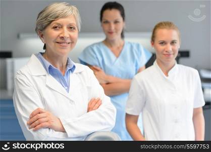 Medical team of three professional woman at dental surgery portrait