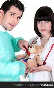 Medical team operating on a teddy bear