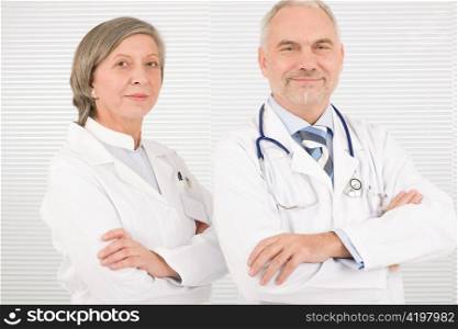 Medical team senior male doctor with professional female colleague portrait