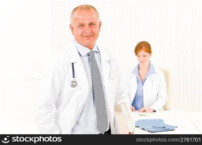Medical team senior male doctor with professional female nurse portrait