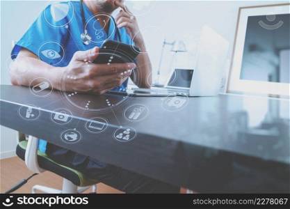 Medical technology concept.Doctor hand working with smart phone and laptop with digital tablet computer in modern clinic office with virtual screen medical chart interface