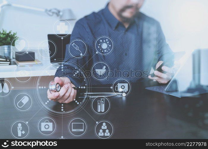 Medical technology concept. Doctor hand working with smart phone,laptop,modern digital tablet dock screen computer in modern clinic office room,virtual screen medical chart interface