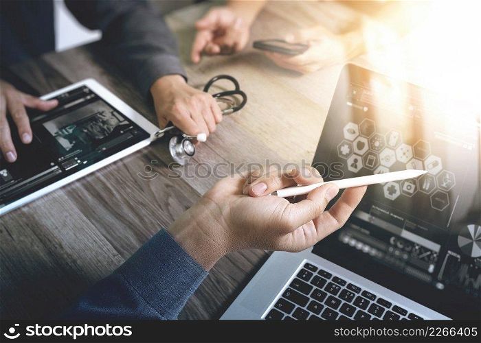 Medical technology network team concept. Doctor hand working with smart phone modern digital tablet and laptop computer with medical chart interface, Sun flare effect photo 