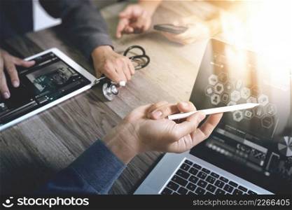 Medical technology network team concept. Doctor hand working with smart phone modern digital tablet and laptop computer with medical chart interface, Sun flare effect photo 