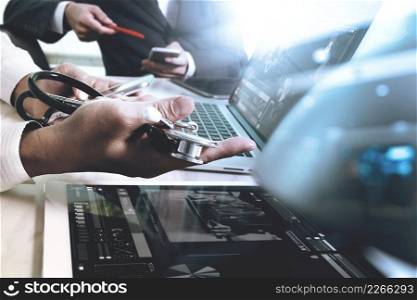 Medical technology network team meeting concept. Doctor hand working smart phone modern digital tablet laptop computer medical chart interface, double exposure effect photo
