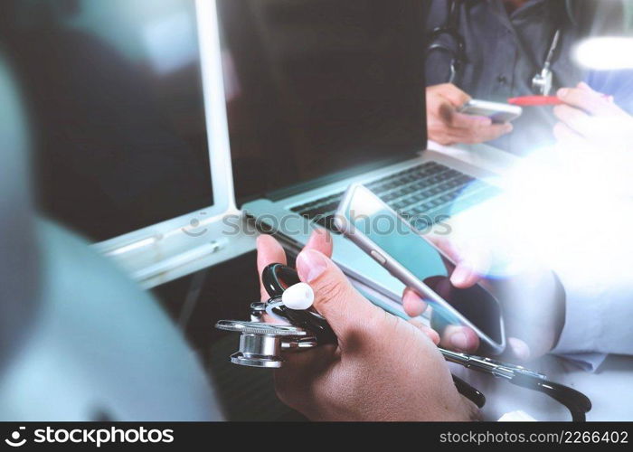  Medical technology network team meeting concept. Doctor hand working smart phone modern digital tablet laptop computer, sun flare effect photo