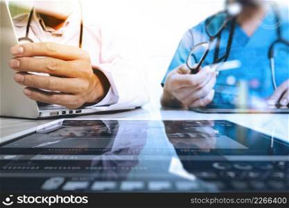 Medical technology network team meeting concept. Doctor hand working with smart phone modern digital tablet and laptop computer with graphics chart interface, Sun flare effect photo