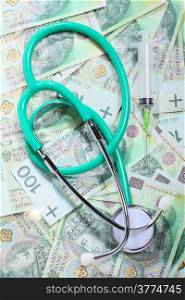 medical treatment and high cost for a good health care service concept: green stethoscope on money polish zloty paper banknotes