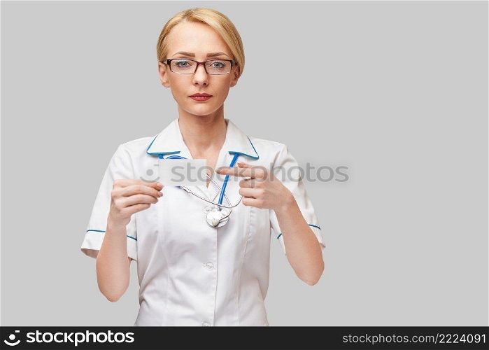 Medical worker doctor or nurse showing blank business card sign with copy space for text or design.. Medical worker doctor or nurse showing blank business card sign with copy space for text or design