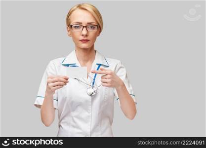 Medical worker doctor or nurse showing blank business card sign with copy space for text or design.. Medical worker doctor or nurse showing blank business card sign with copy space for text or design