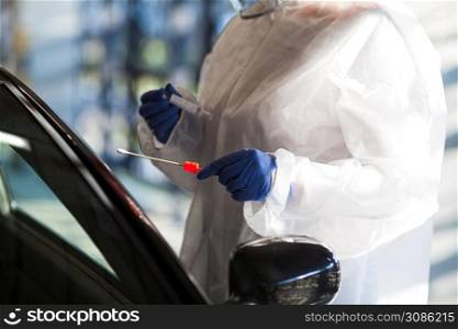 Medical worker performing drive through Coronavirus COVID-19 test,DNA swab specimen collection,point of care check,UK/US mobile testing center,global worldwide pandemic crisis,immunity & immune system