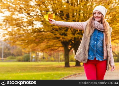 Medication, health concept. Woman with vitamins for autumn. Attractive lady with long hair wearing warm autumnal clothing.. Woman with vitamins for autumn.