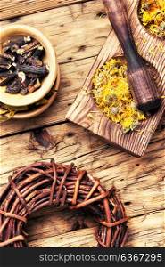 medicinal herbs and plants. wooden mortar with medicinal herbs and plants
