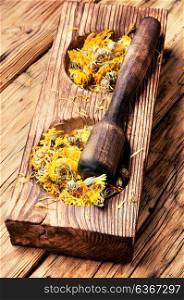 medicinal herbs and plants. wooden mortar with medicinal herbs and plants