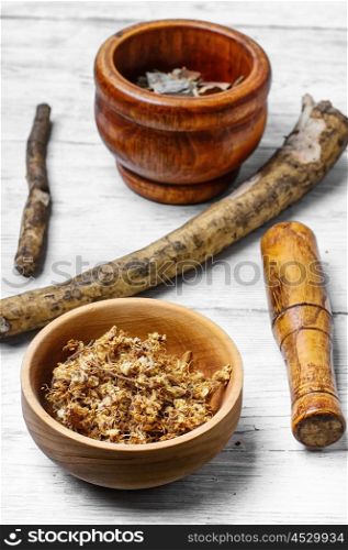 Medicinal plants,herbs in the wooden bowl and inula root