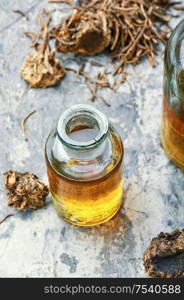 Medicinal tincture from the roots and rhizomes of valerian.Herbal medicine.Medicinal plant. Bottle of herbal tincture