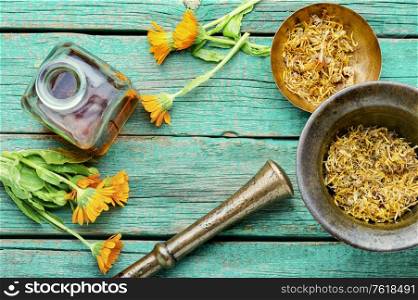 Medicinal tincture of calendula flowers healing herbs in alternative medicine.Tincture bottle and healing herbs. Calendula healing herbs