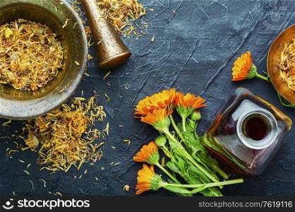 Medicinal tincture of calendula flowers, medicinal wild herbs.. Marigold in herbal medicine
