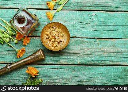 Medicinal tincture of calendula flowers, medicinal wild herbs.Tincture bottle and healing herbs. Calendula in herbal medicine