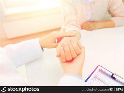 medicine, age, health care and people concept - close up of doctor or nurse checking senior woman pulse at hospital ward. doctor checking senior woman pulse at hospital