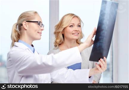 medicine, age, health care and people concept - happy woman patient and doctor with spine x-ray scan meeting in medical office