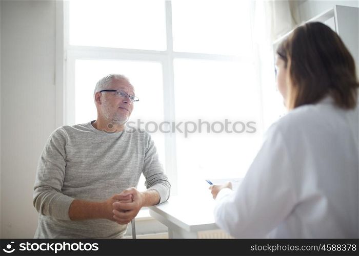 medicine, age, health care and people concept - senior man and doctor meeting in medical office at hospital. senior man and doctor meeting at hospital