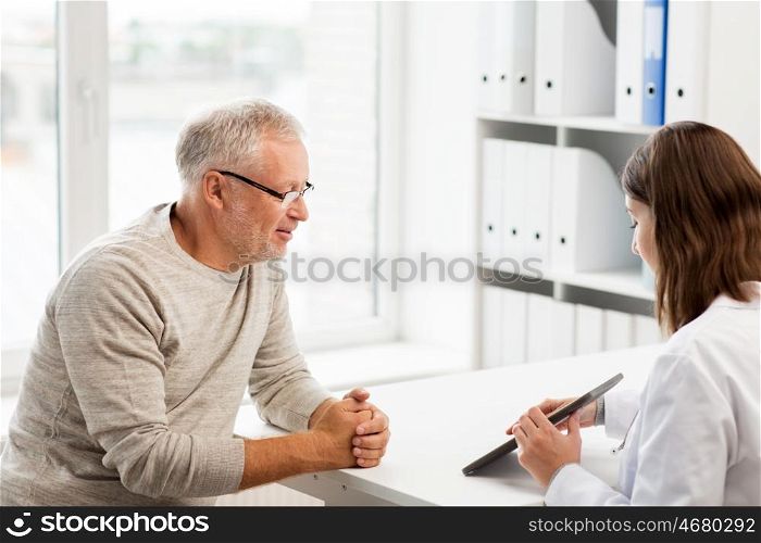 medicine, age, health care and people concept - senior man and doctor with tablet pc computer meeting in medical office at hospital